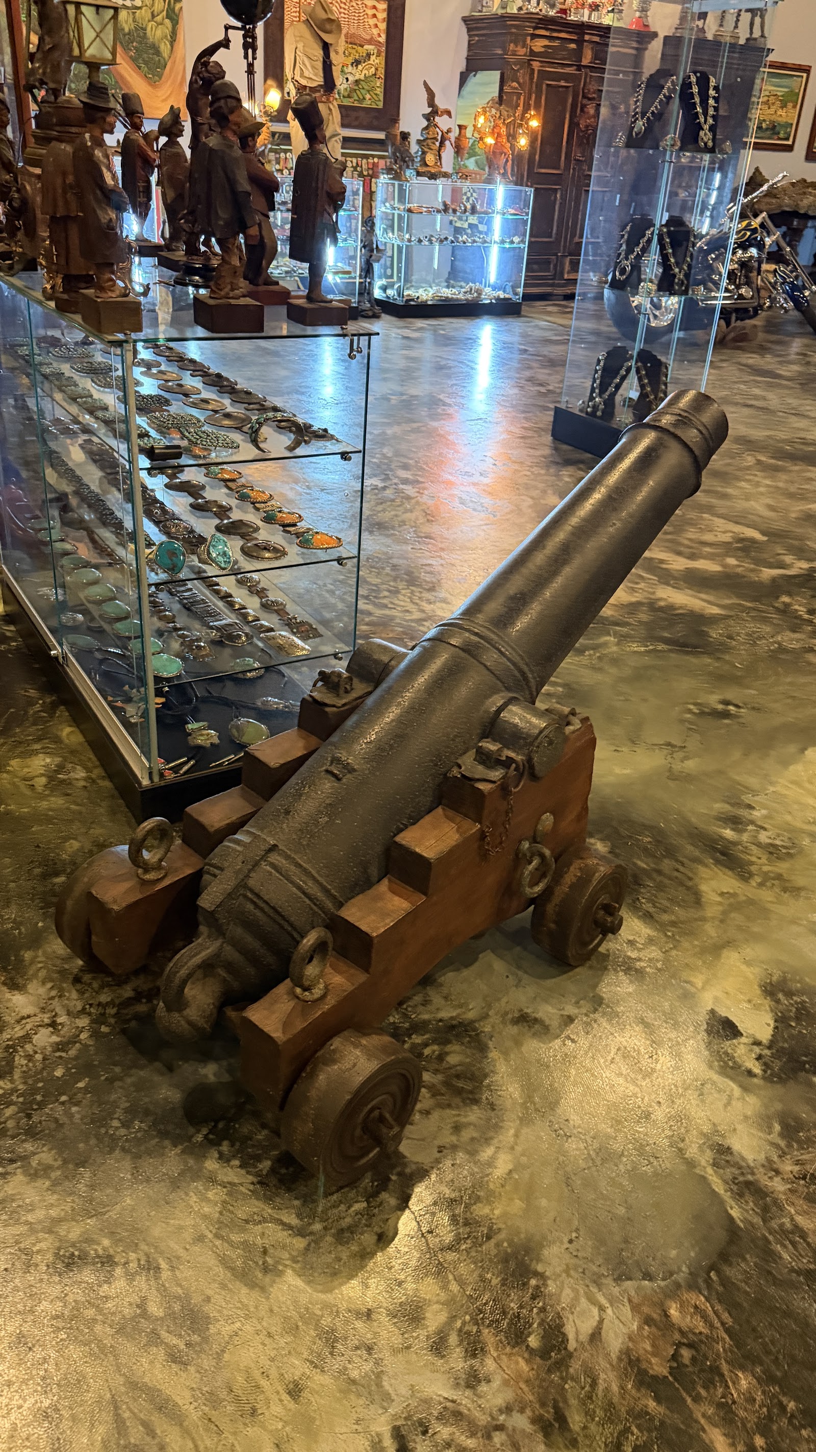 Bronze cannon beside Native American silver and turquoise